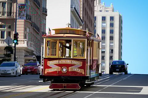 In frame: A cable car dedicated to Tony Bennett makes its way up California Street to Nob Hill in San Francisco