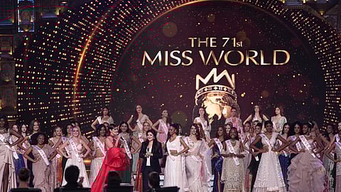 Archana Kochhar flanked by participants at the 71st Miss World
