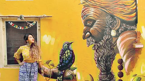 Sneha Chakraborty with her mural in Jaipur