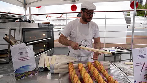 In frame: French baker Tony Dore prepares baguettes, like those that will be served during the. Olympic Games