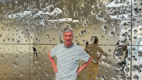 In frame: Italian artist Maurizio Cattelan poses with his installation