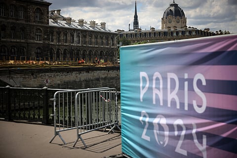 Workers operate along the Seine river at the 2024 Summer Olympic