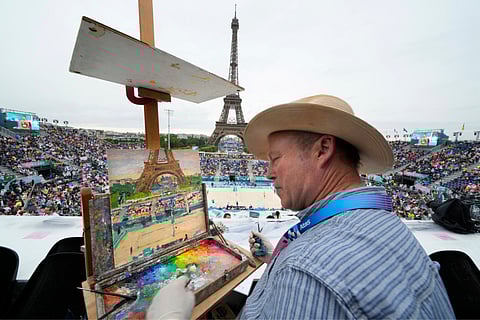 Peter Spens, of London, England, paints the scene at Eiffel Tower Stadium during a beach volleyball match at the 2024 Summer Olympics (July 27)
