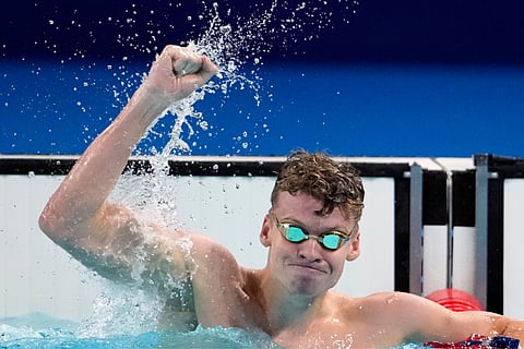 Leon Marchand, of France, celebrates after winning the men's 200-meter breaststroke final at the 2024 Summer Olympics (July 31) in Nanterre, France