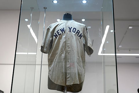The 1932 Babe Ruth game worn New York Yankees World Series 'Called Shot' jersey is displayed in a sealed glass box at Heritage Auction in Irving, Texas (Aug. 21, 2024)