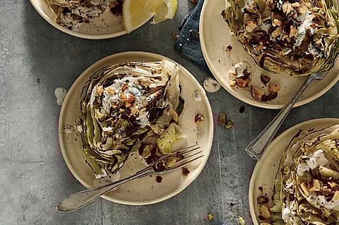 This image released by Workman Publishing Group shows a recipe for grilled wedge salad with smoky ranch dressing from the cookbook 'How to Grill Vegetables' by Steven Raichlen