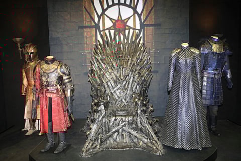 The Iron Throne and costumes on display during the launch of The Game of Thrones Touring Exhibition at the Titanic Exhibition centre in Belfast, Northern Ireland (April 10, 2019)