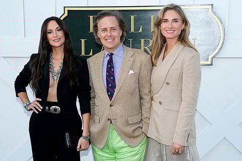 Kacey Musgraves (left), David Lauren and Lauren Bush Lauren attend the Ralph Lauren Spring/Summer 2025 fashion show as part of New York Fashion Week (Sept. 5, 2024) at Khalily Stables in Bridgehampton, NY