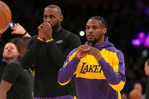 Los Angeles Lakers forward LeBron James, left, and guard Bronny James warm up before an NBA basketball game against the Minnesota Timberwolves on Tuesday, Oct. 22, 2024, in Los Angeles