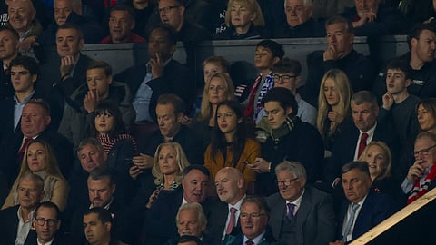 American singer-songwriter and actress Olivia Rodrigo, centre, attends the Premier League soccer match between Manchester United and Chelsea at Old Trafford stadium