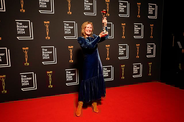 Samantha Harvey poses with the trophy after winning the Booker Prize award 2024, in London, Tuesday, Nov. 12, 2024