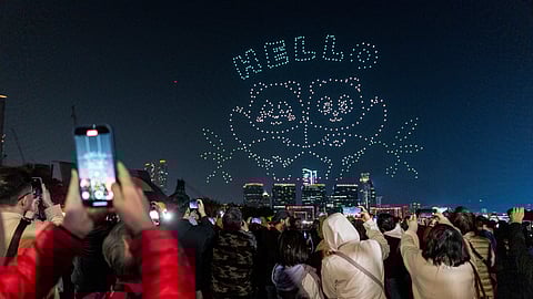 People watch the panda-themed drone show at the waterfront of the Victoria Harbour in Hong Kong, Saturday