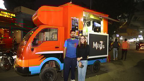 Rishav & Tanisa in front of their truck