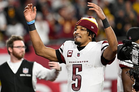 Washington Commanders quarterback Jayden Daniels (5) celebrates after an NFL wild-card playoff football game against the Tampa Bay Buccaneers in Tampa, Fla., Sunday, January 12, 2025