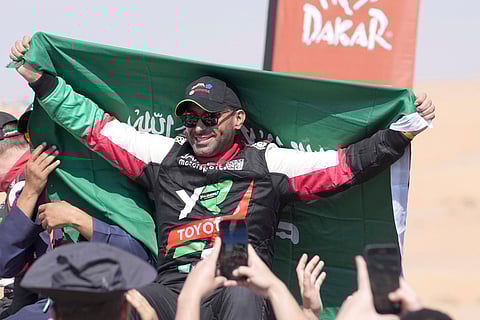 Driver Yazeed Al Rajhi celebrates after winning the Dakar Rally
