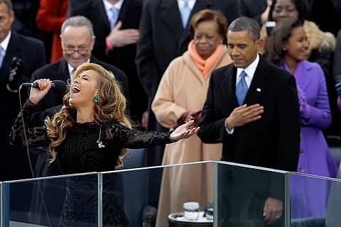 President Barack Obama, right, listens as Beyonce sings the National Anthem at the ceremonial swearing-in at the U.S. Capitol during the 57th Presidential Inauguration in Washington, Jan. 21, 2013