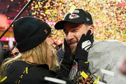 Kansas City Chiefs tight end Travis Kelce, right, is congratulated by Taylor Swift as they celebrate the Chiefs victory over the Buffalo Bills in the AFC Championship NFL football game, Sunday, Jan. 26, 2025, in Kansas City, Mo.