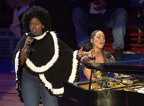 FILE - Alicia Keys, right, and Angie Stone, perform 'America the Beautiful' during the NBA All-Star game in Philadelphia, Feb. 10, 2002