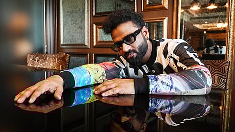 Music composer DSP seen posing in a trendy jacket and sunglasses