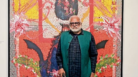 Manu’s Parekh in front of one of his paintings