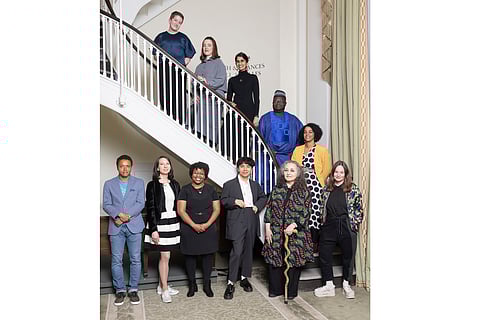 This image released by the Whiting Foundation shows keynote speaker Ocean Vuong, bottom center, with Whiting Awards recipients, counter clockwise-from left, Elwin Cotman, Annie Wenstrup, Karisma Price, Emil Ferris, Eliza Birkenmeier, Aisha Sabatini Sloan, Samiel Kọ́láwọlé, Shubha Sunder, Sofie Thanhauser, and Claire Luchette at the 40th Annual Whiting Awards in New York on April 9, 2025