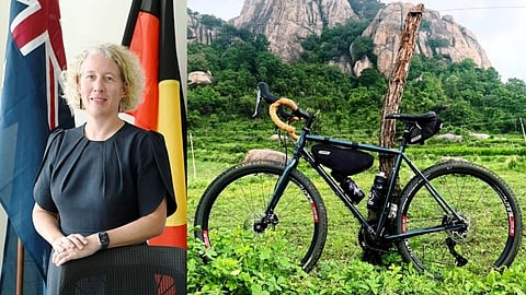 Picture of Australian Consul General in Bengaluru, Hilary McGeachy, on the left; a cycle parked in front of Skandagiri Hills on the right.