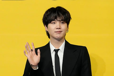 Suga, a member of South Korean K-pop band BTS, poses for photographers ahead of a press conference to introduce their new single Butter in Seoul, South Korea on May 21, 2021