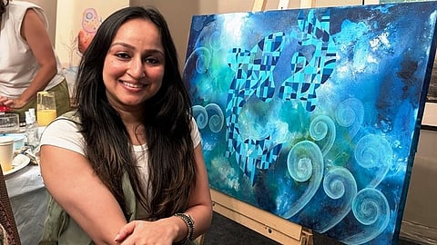 Artist Pragya Jain poses with her work of art at SDGs Through Arts: India Edition