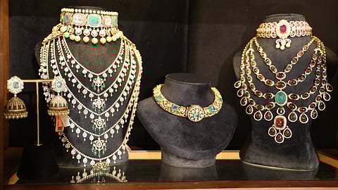 Necklaces designed by Nilaya Reddy, glowing subtly under soft light.