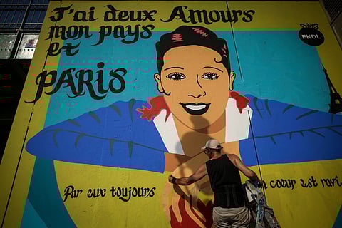 Artist Franck Duval, aka FKDL, works on a mural of U.S.-French entertainer and civil rights activist Josephine Baker in Paris, Saturday, July 19, 2025