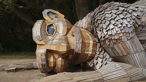 Giant trolls built from trash call for kinder living
