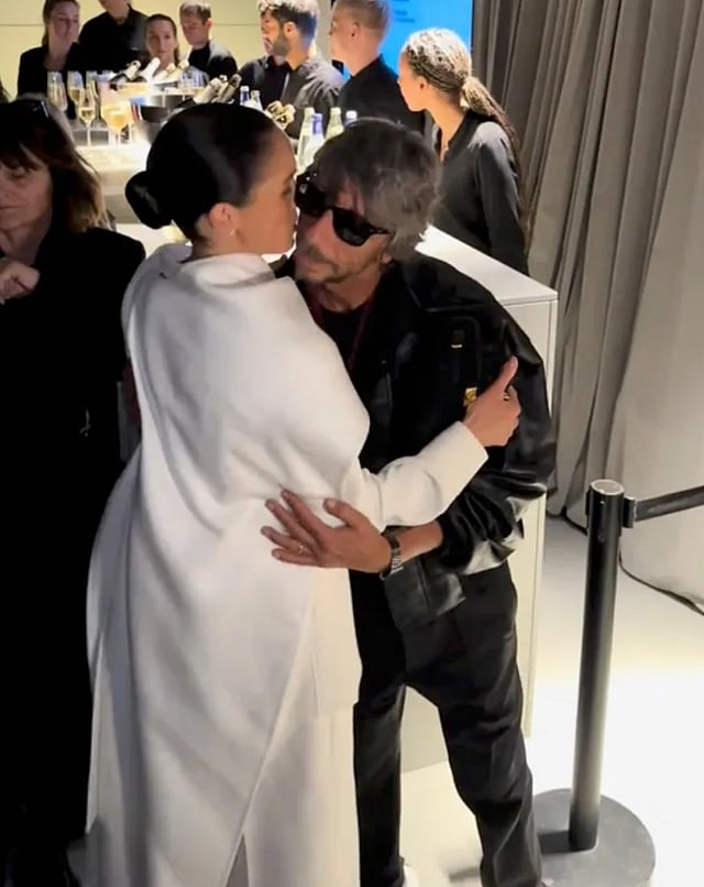 Pierpaolo Piccioli hugs Meghan at the show