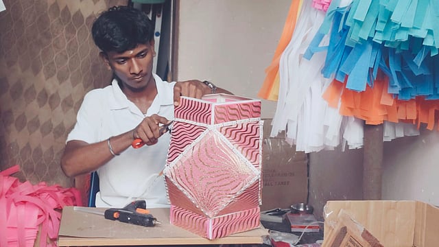 An artisan works on the a kandeel