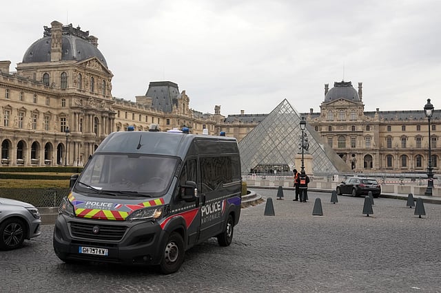 A police car patrols in the courtyard of the closed Louvre museum in Paris