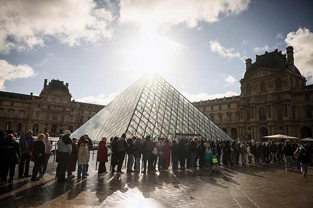 Visitors queue outside the Louvre museum, one week after the robbery on Sunday