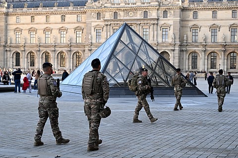 Soldiers patrol in the courtyard of the Louvre museum