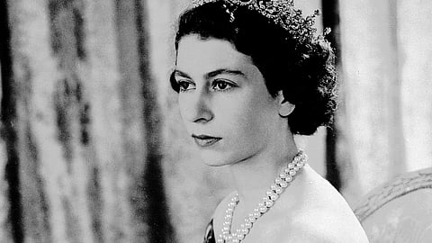 Britain's Queen Elizabeth II, then Princess Elizabeth, wears a silver gown with a diamond tiara and pearl necklace