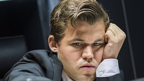 Magnus Carlse shoves away camera