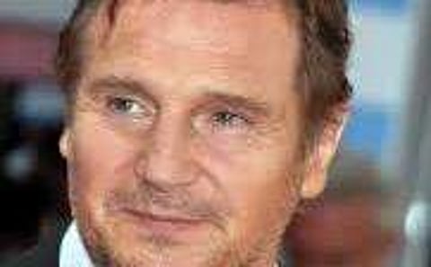 Liam Neeson practices yoga with Ralph Fiennes