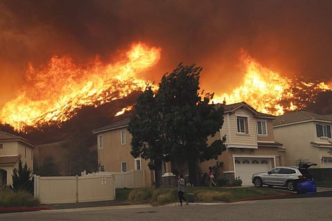 A wildfire approaches a residential subdivision Oct. 24, 2019, in Santa Clarita, Calif. (AP Photo/Marcio Jose Sanchez)