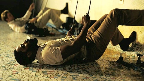 John David Washington, with Robert Pattinson (background), in Tenet