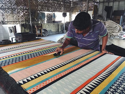A block printer at work at Studio Syu