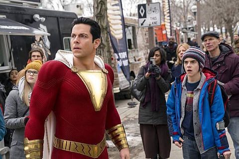 This image released by Warner Bros. shows Zachary Levi, left, and Jack Dylan Grazer in a scene from 'Shazam!' (Steve Wilkie/Warner Bros. Entertainment via AP)
