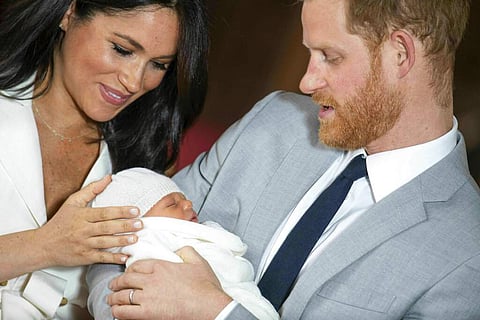 Harry and Meghan at a photocall with their newborn son (Dominic Lipinski/Pool via AP)