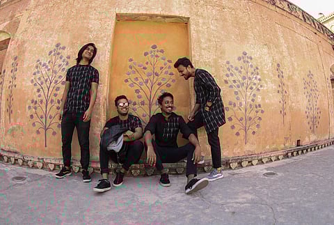 The band wears ensembles from Ativa