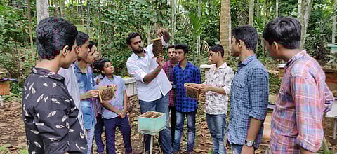 Anoop with kids on a farm visit