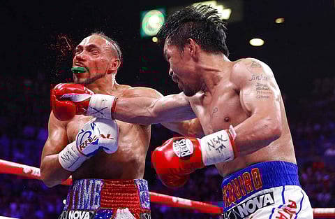 Manny Pacquiao lands a punch against Keith Thurman (AP Photo/John Locher)