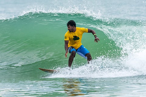 A surfer at Covelong Point Surf Music Yoga Festival