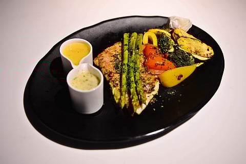 Red snapper in a lemon garlic marinade with orange beurre blanc & garlic butter sauces