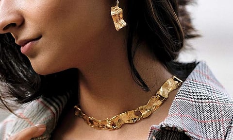 A relaxed form gold choker from the Bhaane X Misho capsule collection